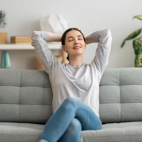 Woman relaxing in her air conditioned home