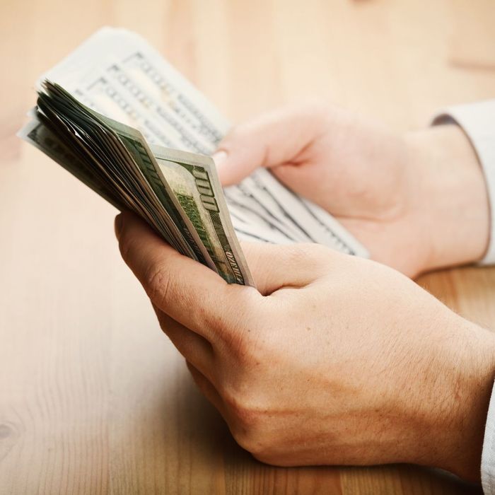 A person counting cash. A person counting cash.