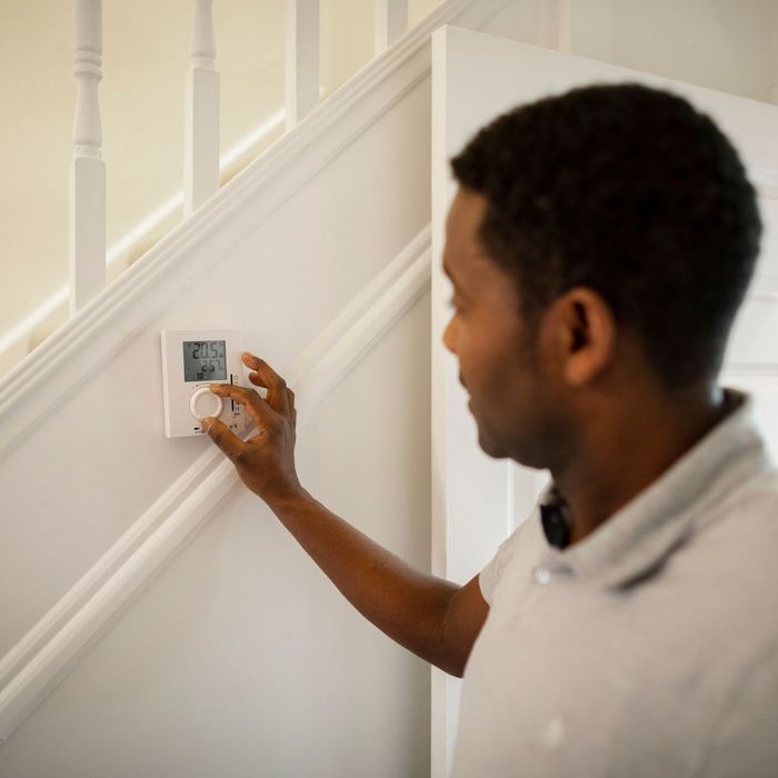 man altering home thermostat