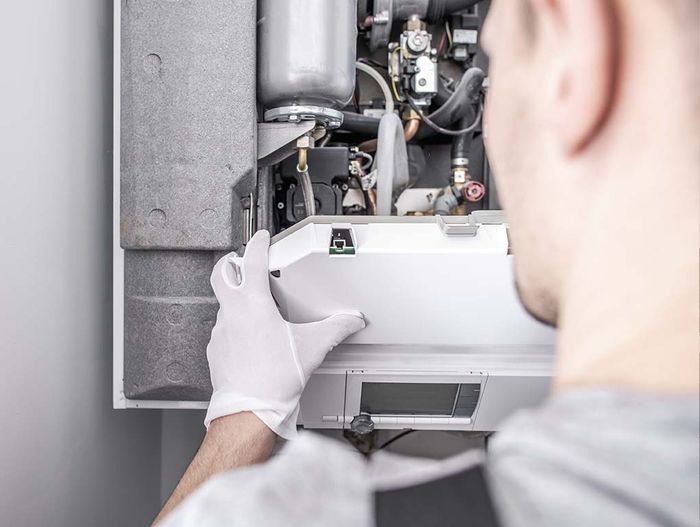 Professional installing heating system in home
