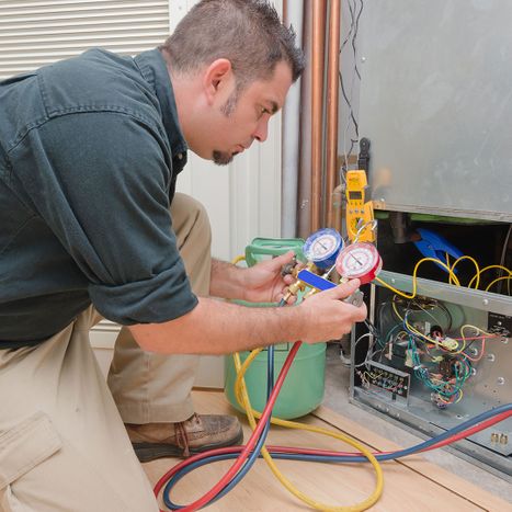Technician performing HVAC maintenance