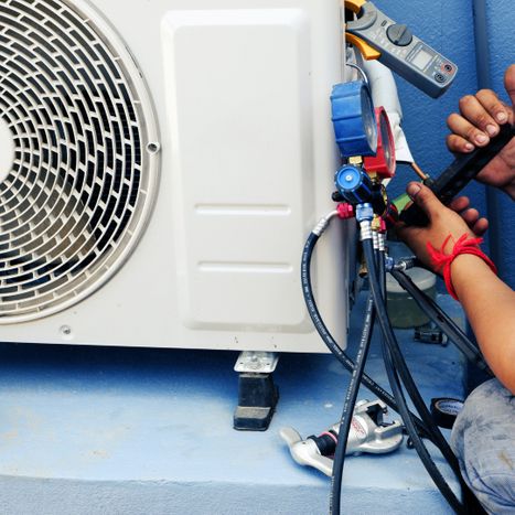 image of an AC unit being repaired