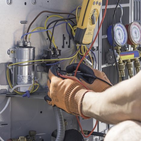 HVAC tech working on a heat pump