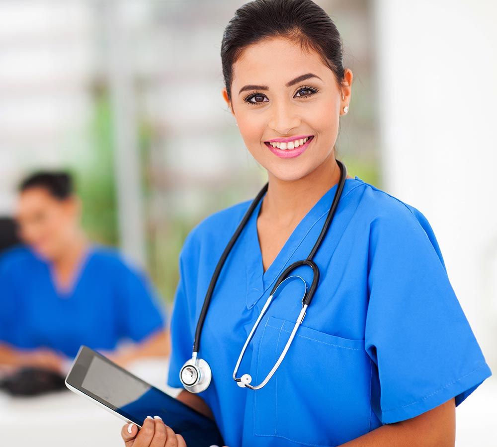 smiling nurse holding a tablet