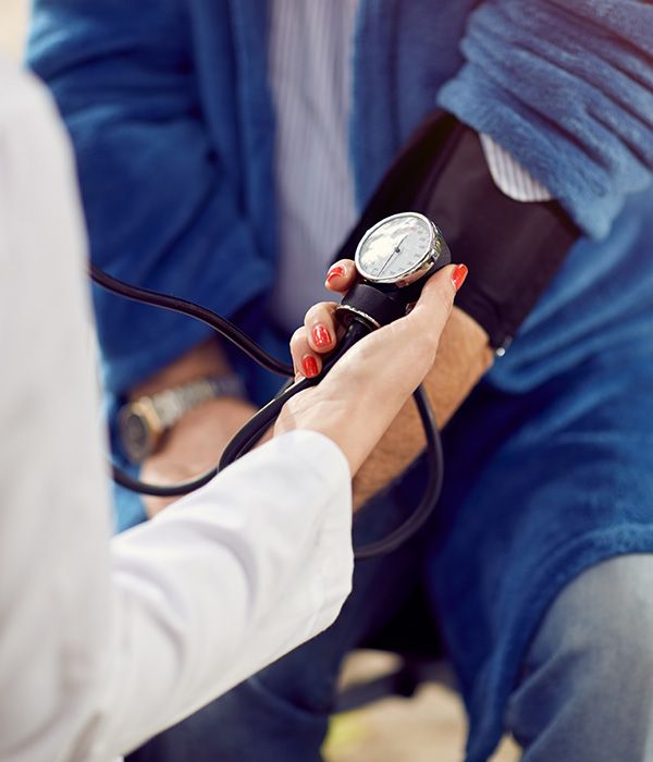 nurse taking blood pressure on a patient