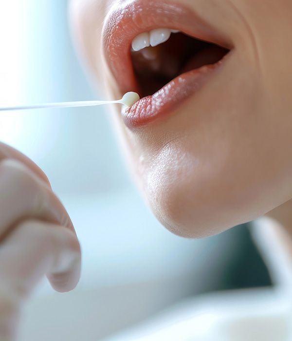 woman having saliva test done