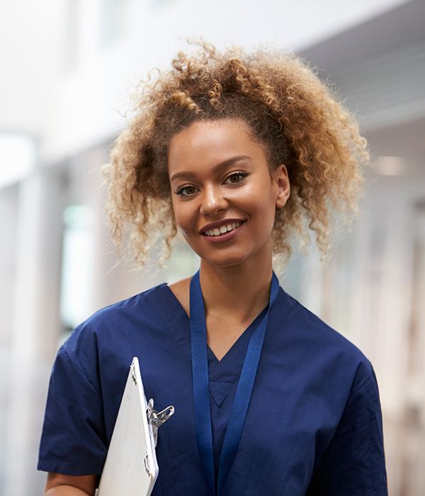 smiling nurse holding a clipboard