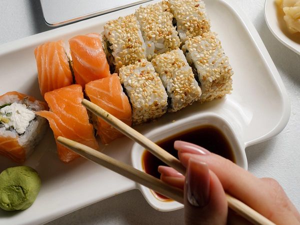 Woman Eating Sushi at Her Desk