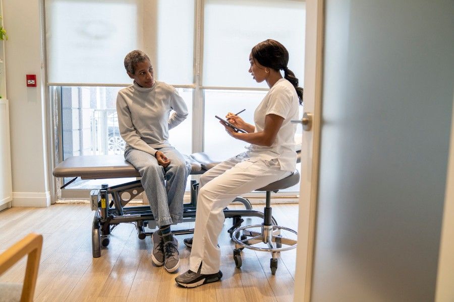 woman speaking chiropractor on first visit