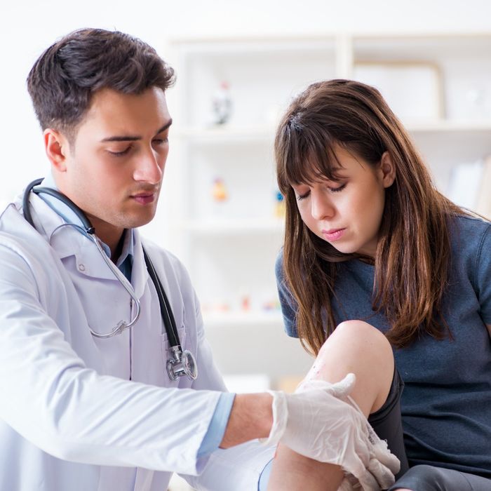 doctor looking at patients leg