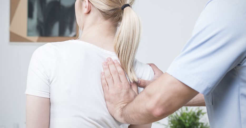 Image of a woman getting a chiropractic adjustment