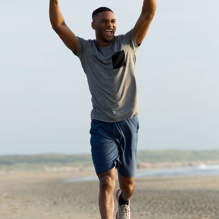 happy man jogging on the beach