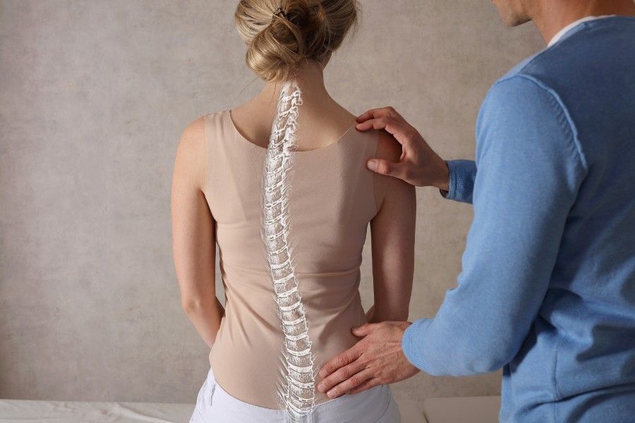 chiropractic adjustment with spine overlay on woman