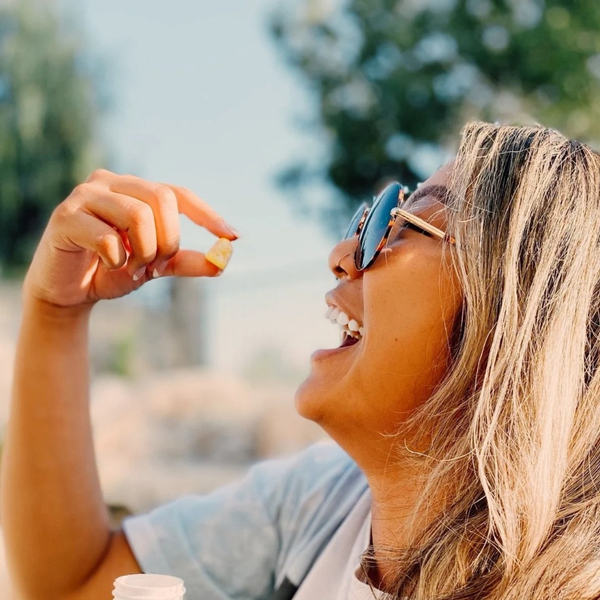 woman taking gummy