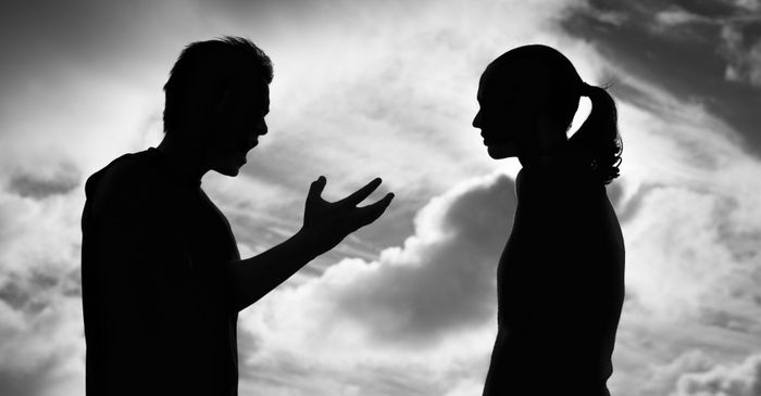 Silhouette of man and woman arguing