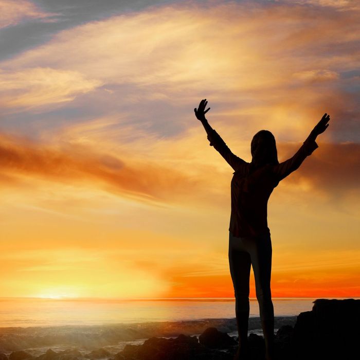 woman looking empowered in the sunrise