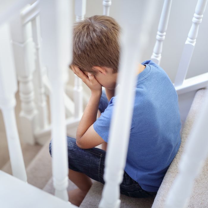 Upset child sitting on a staircase