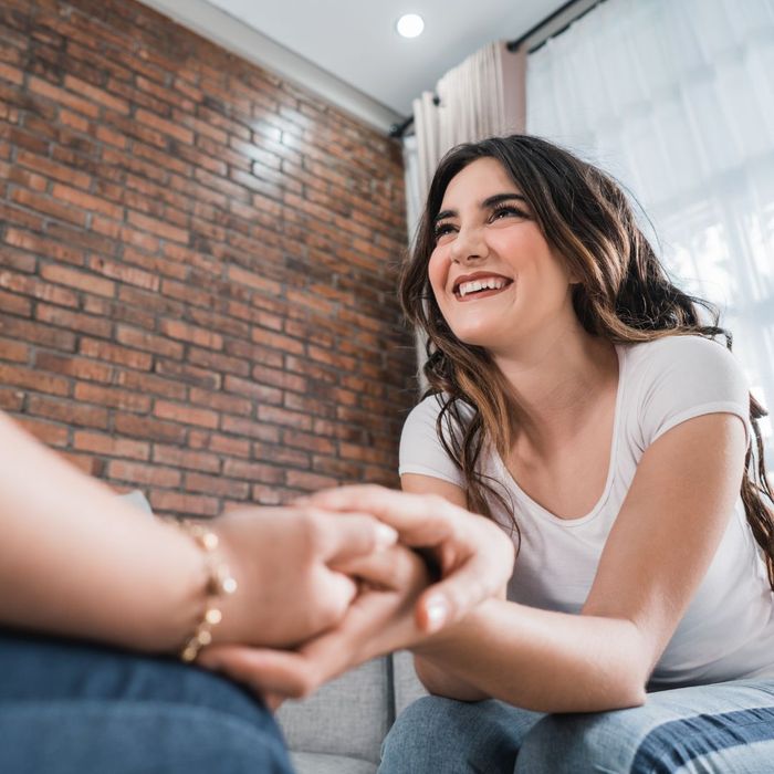 woman holding friends hand