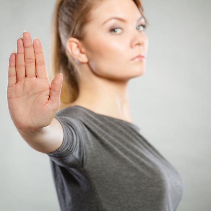 woman holding up hand saying stop