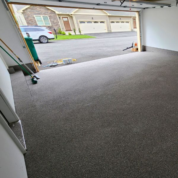 epoxy flooring in a garage with the garage door open