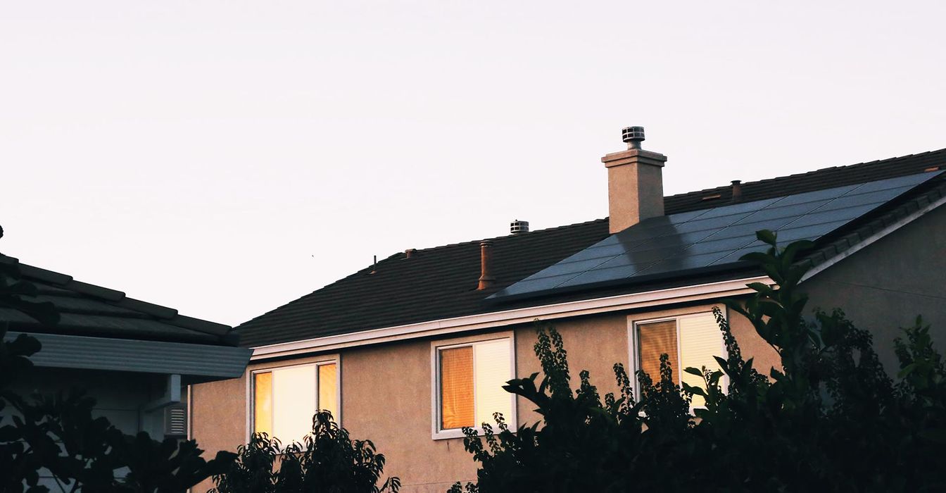 House with solar panels on roof at dusk