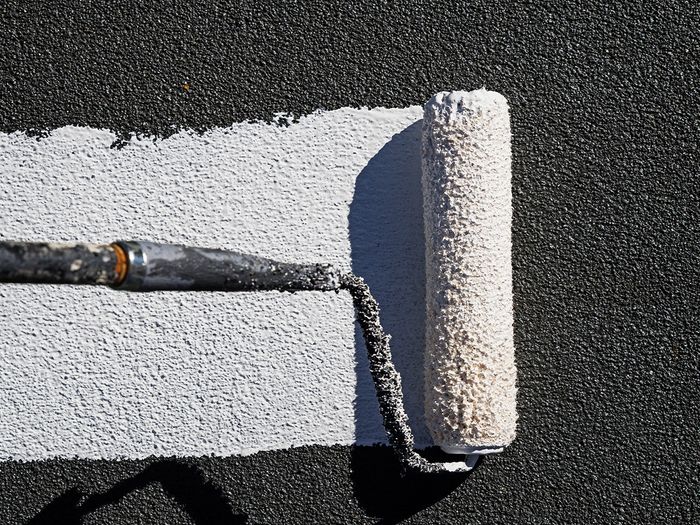 Paint roller with white paint on it