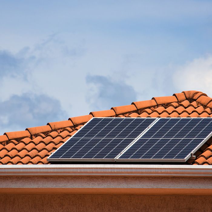 Solar panels on a home with red clay tile shingles