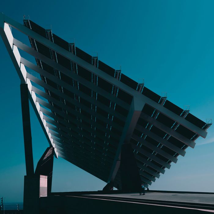 Close up of a side view of solar panels pointed up at the sky