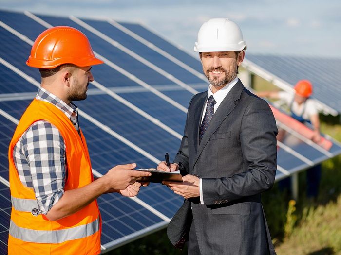 Two men discussing solar panel installation