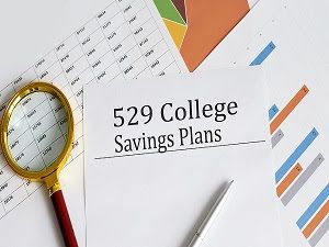 529 College Savings Plans document with charts and magnifying glass, symbolizing education planning and tax-advantaged savings