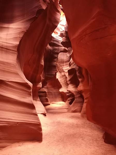 Narrow sandstone canyon passage with dramatic light and curves, representing Arizona nature, travel, and outdoor living Scenic view of a red rock slot canyon in Arizona, symbolizing exploration, adventure, and retirement freedom in the Southwest