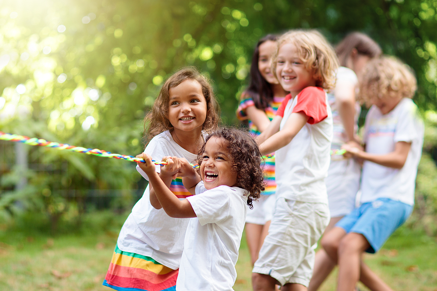 Children Playing Tug of War in a Summer Park