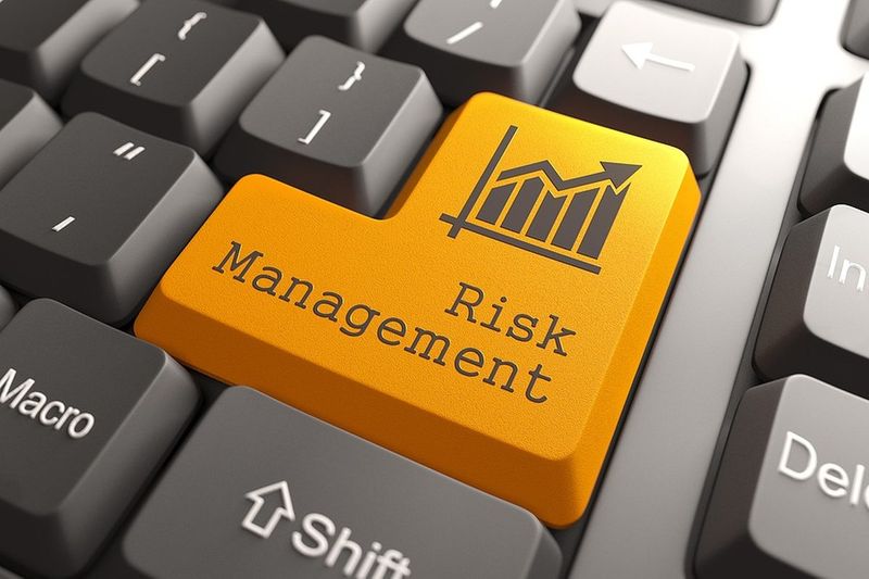 Orange risk management keyboard key with a financial growth chart icon, representing investment risk strategies — J. Martin Wealth Management, Arizona. Risk Management keyboard key with financial chart icon