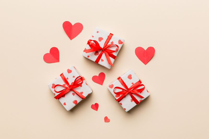 Heart-Themed Gifts with Red Bows and Paper Hearts