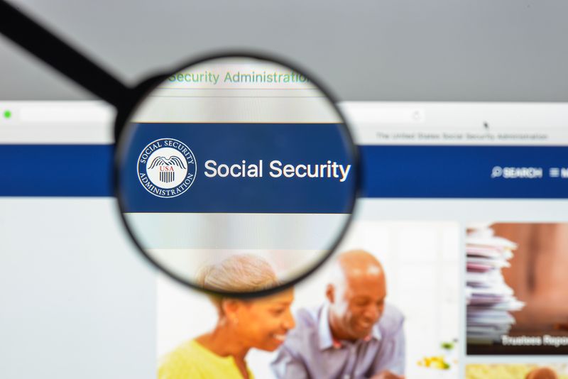 Magnifying glass focusing on the Social Security website header, highlighting the Social Security Administration logo