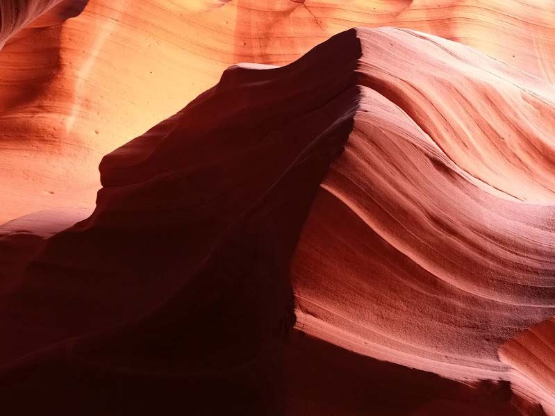 Wavy red rock formation in Antelope Canyon, Arizona, highlighting the Howling Wolf shape carved by wind and time Howling Wolf rock formation inside Antelope Canyon, Arizona, showcasing natural beauty and iconic red sandstone curves