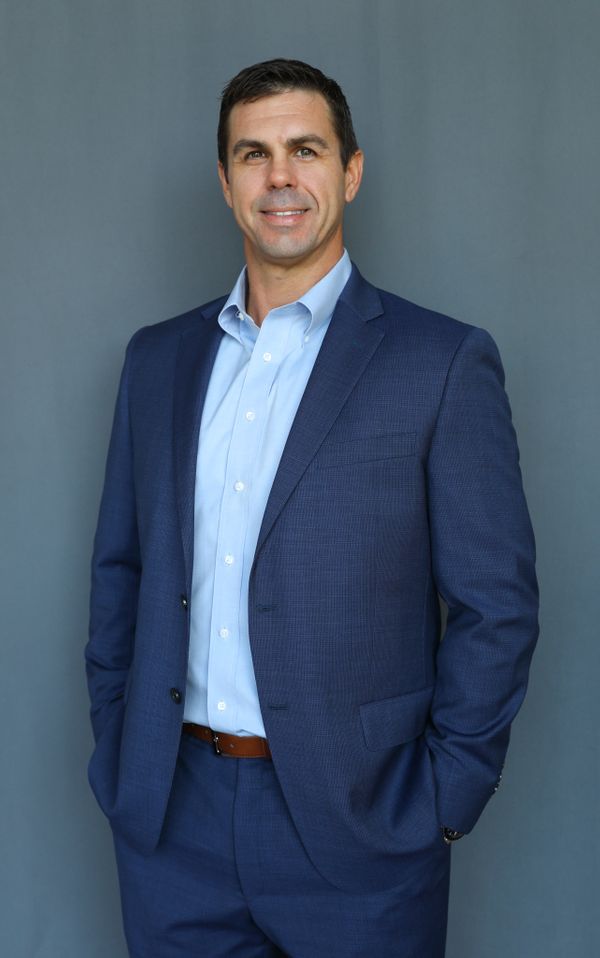 Professional headshot of Jeff Martin, independent financial advisor in Arizona, offering retirement and investment guidance Jeff Martin, fiduciary financial advisor in Gilbert, Arizona, wearing a navy suit and smiling confidently