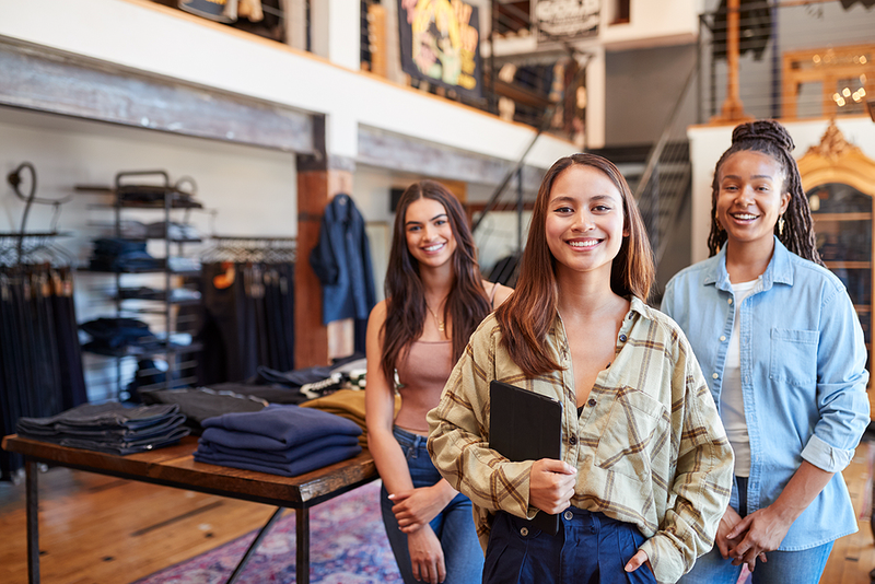 Female Entrepreneurs Smiling in Clothing Store