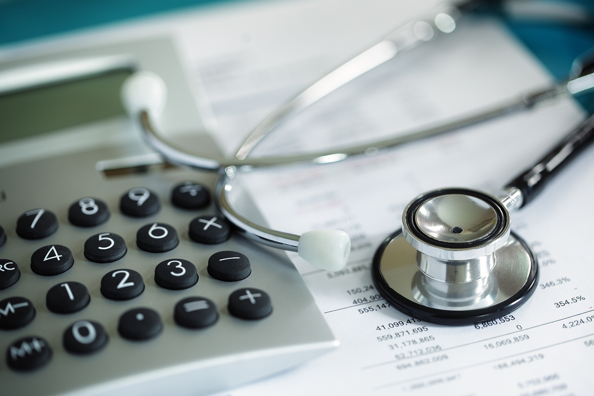 Stethoscope and Calculator on Financial Documents