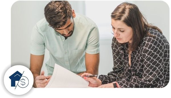 Two homebuyers looking over some paperwork