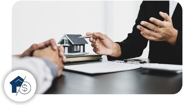 A real estate agent talks through paperwork with a client
