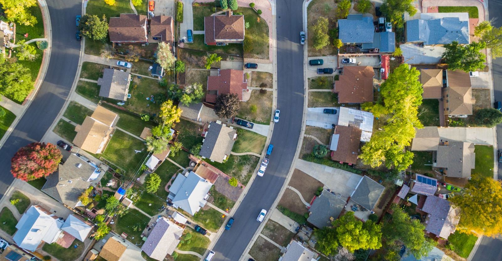 An aerial view of a neighborhood with many roofs. 