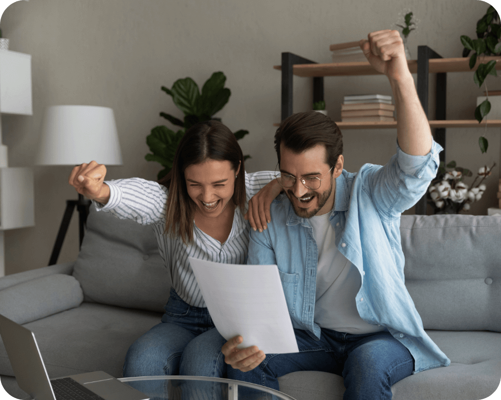 two people excited looking at paperwork