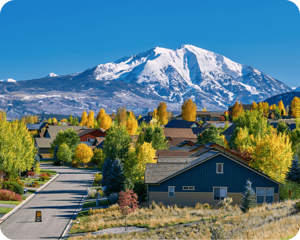 a neighborhood with mountains behind it 