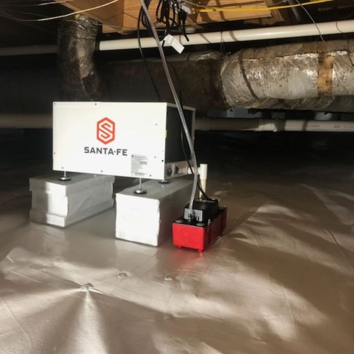 Crawl space dehumidifier setup on vapor barrier sheeting