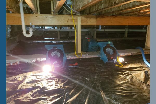 Fans running in a crawlspace to help mitigate mold and humidity