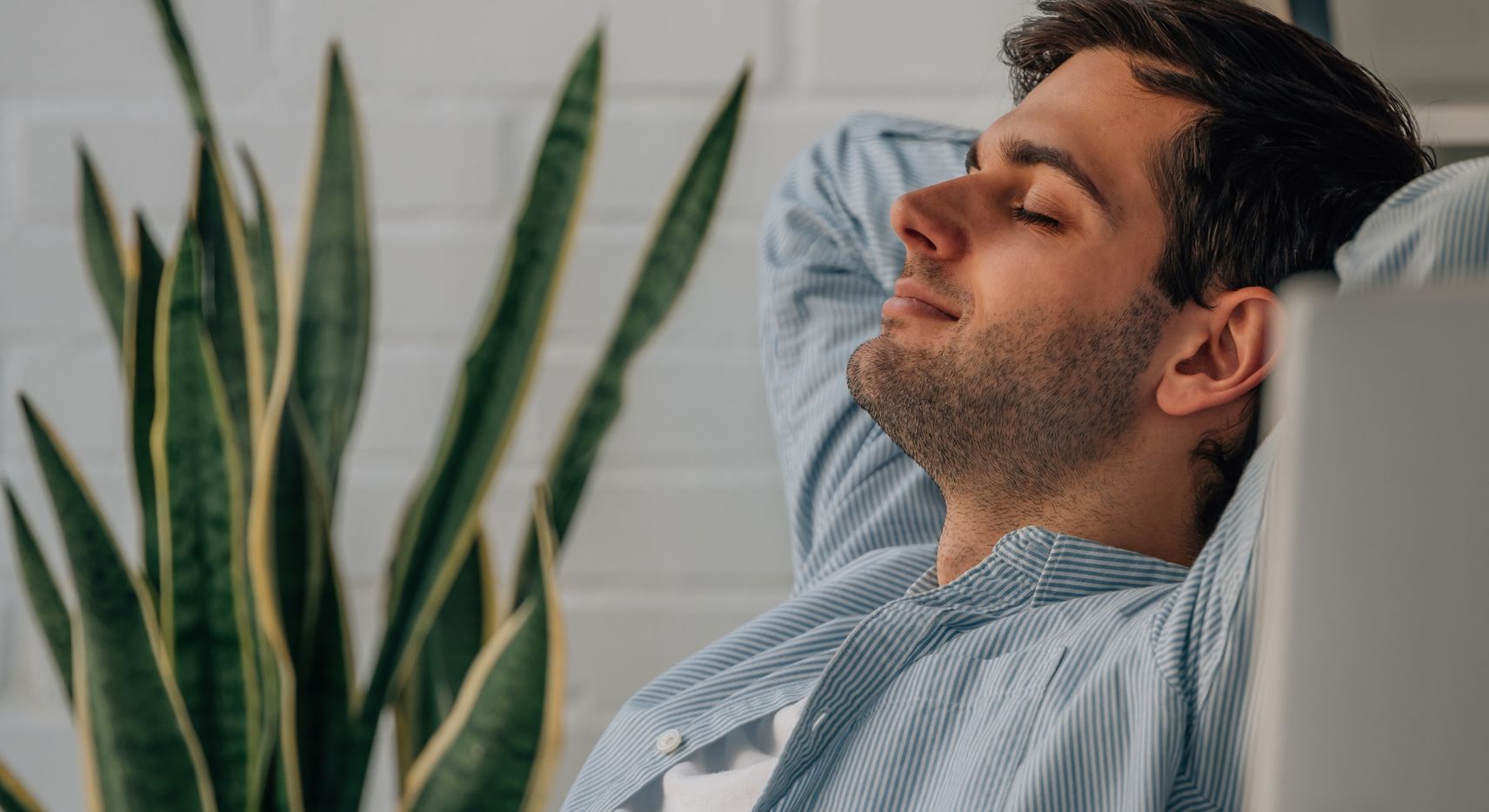 Man relaxing and leaning back in his chair