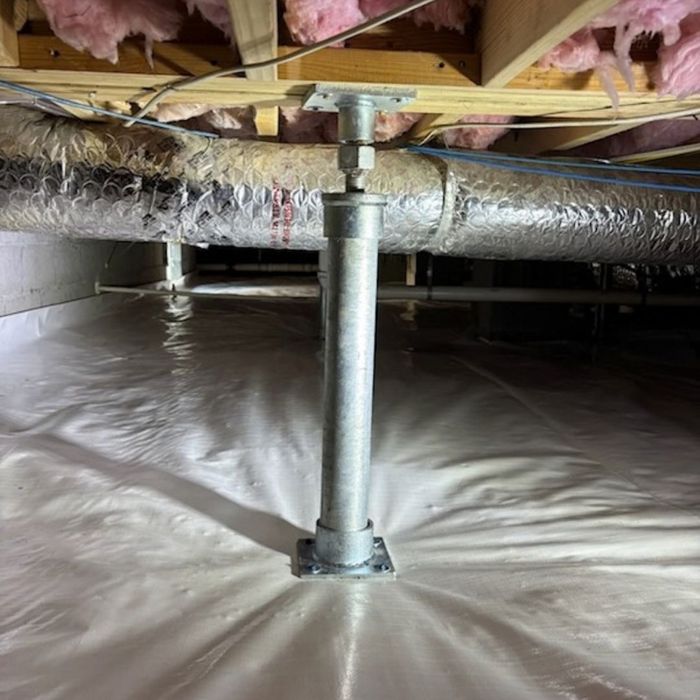 Steel adjustable jack post supporting floor joists in an encapsulated crawl space