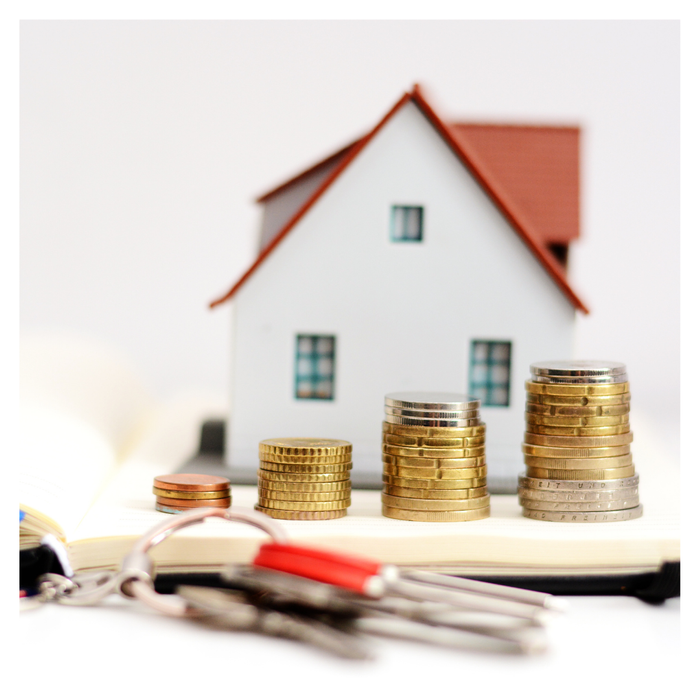 model house with increasing stacks of coins