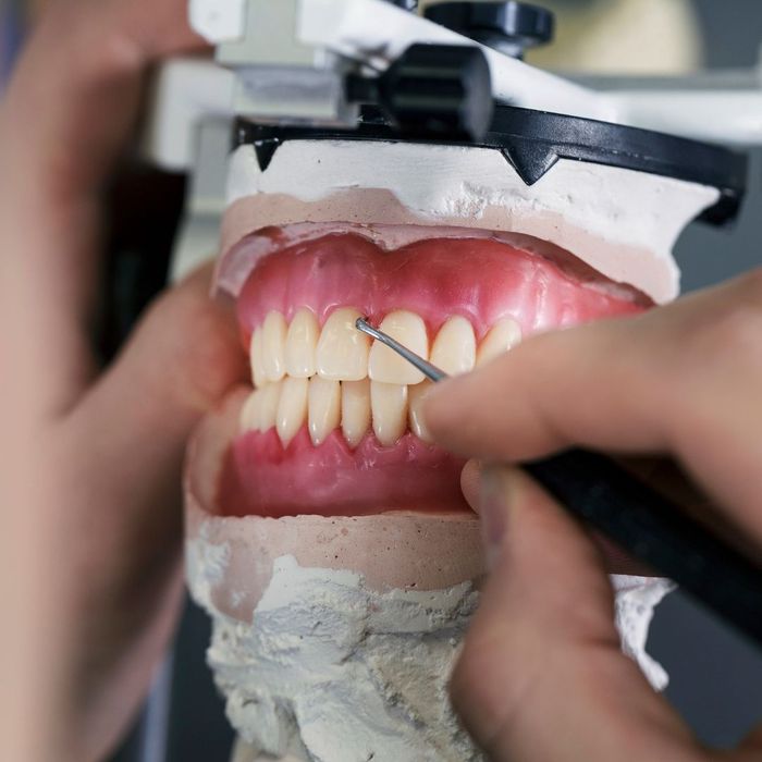 Person sculpting dentures